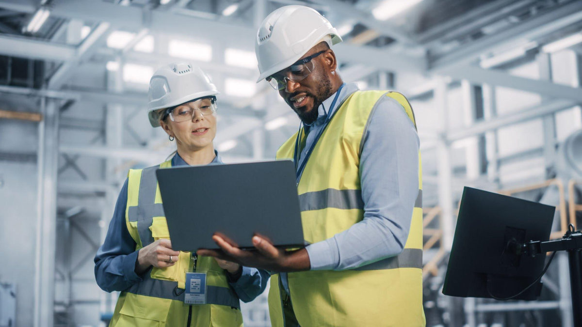 WSH professionals reviewing site plans on a laptop