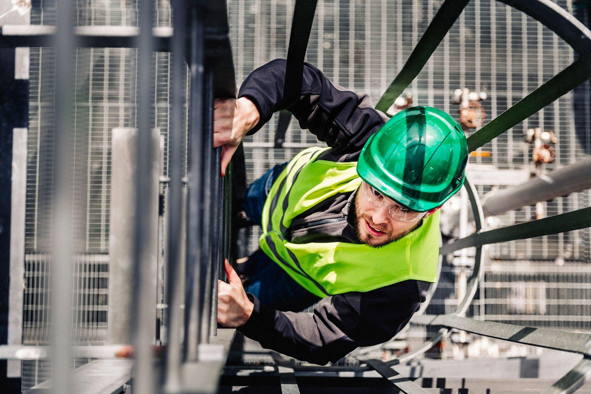 Safety professional climbing on site infrastructure